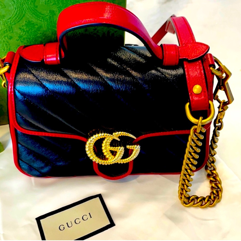 Gucci black and red marmot leather handle bag with remove able strap.